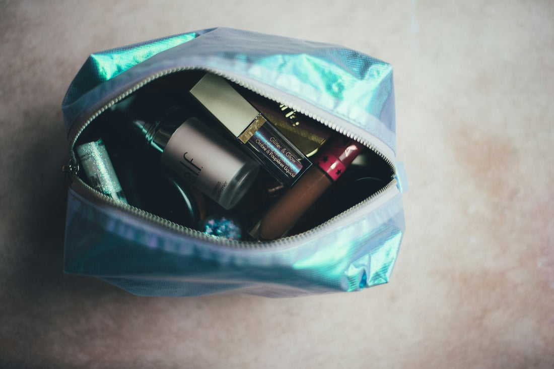 Open toiletry bag full of small bottles and products