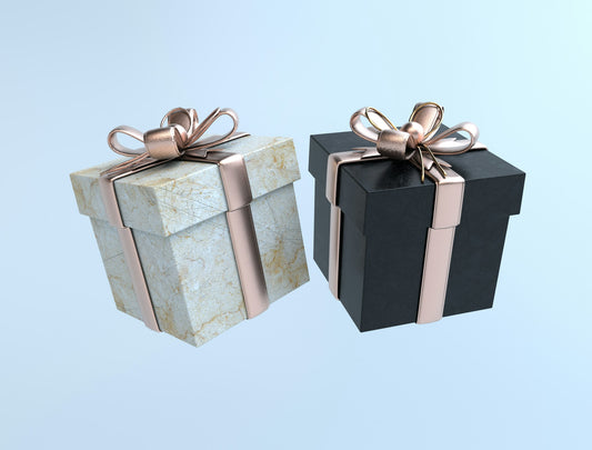 Two gift boxes, one black and one white, tied with gold bows